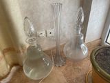 three glass vases and a glass vase on the floor
