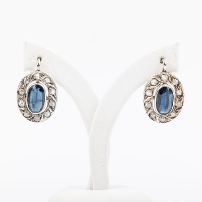 an image of a pair of earrings with a blue stone