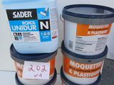 three buckets of paint sitting on top of a table next to each other