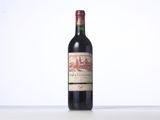 bottle of red wine on a white table with a white background