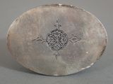 a silver plate with a decorative design on it