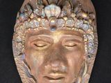 sculpture of a man ' s face with a crown on his head