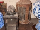 several blue and white vases and a lantern are on a shelf