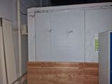 a refrigerator and a refrigerator freezer in a room