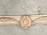 a wooden shelf with a decorative design on top of it