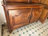 a wooden cabinet with a mirror on top of it