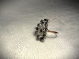 a silver ring with blue and white stones on it