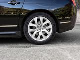 a black car that is parked on the side of the street