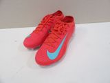 a pair of pink and blue nike shoes on a white surface
