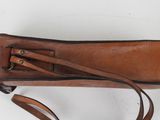 an image of a brown leather purse with a strap on it