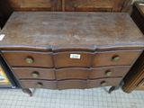 a wooden chest of drawers with a label on it
