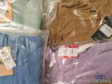 many different colored shirts in plastic bags on a table