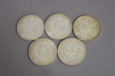six pièces d'argent chinoises sur une surface grise