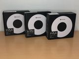 three black and white mp3 players sitting on top of a wooden table