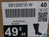 a box with a price tag and a pair of boots on it