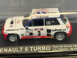 a toy car in a clear case on a table