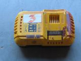 a close up of a yellow power tool on a blue surface