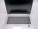 an open laptop computer sitting on top of a white table