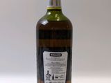 a bottle of olive oil sitting on top of a white table