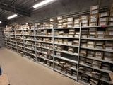 Des rangées de cartons sont empilées sur des étagères dans un entrepôt