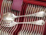 silverware in a red box with a purple napkin and a purple napkin