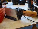 a picture of a corded sander sitting on a table
