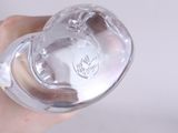a person holding a baby bottle in their hand