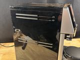 a coffee maker that is sitting on a wooden table