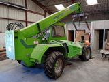 a green crane that is sitting in a building