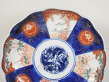 a blue and white plate with orange designs on it