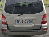 a silver car that is parked on the side of the road