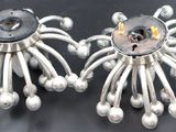 a pair of earrings that are sitting on a table