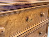 a close up of a wooden dresser in a room