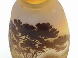 a glass vase with a picture of a tree on it