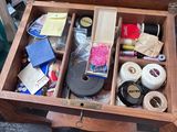 a wooden box filled with assorted items and a mirror