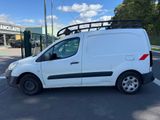 a white van parked in a parking lot next to a building