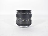a close up of a camera lens on a white surface