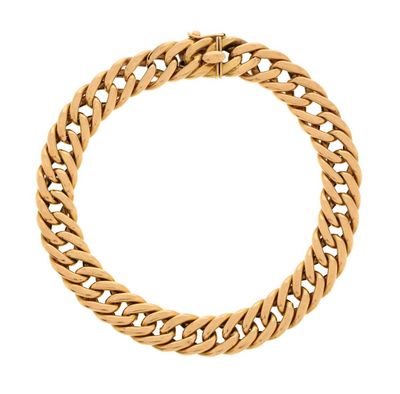 a gold bracelet with a chain on a white background