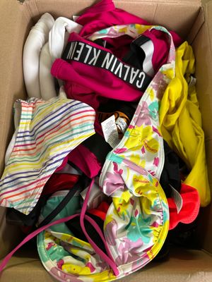 a cardboard box filled with clothes and a pair of shoes