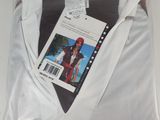the shirt is white and has a picture of a man in a red hat