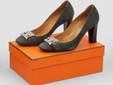 a pair of grey shoes sitting on top of an orange box