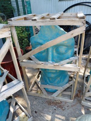 a large blue vase sitting on top of a wooden stand
