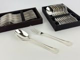 a set of silverware in a black box on a white table