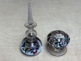 two glass candlesticks sitting next to each other on a table
