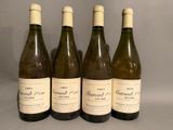 four bottles of wine are lined up on a table