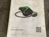 the manual is sitting on the floor next to a bottle of water