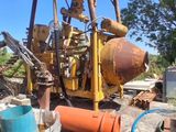 a large yellow machine that is sitting in the dirt