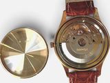 a close up of a watch and a watch face