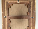 an old wooden frame with a picture hanging on the wall