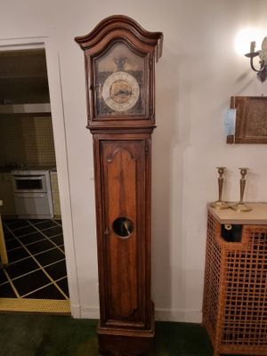 a grandfather clock that is in the corner of a room